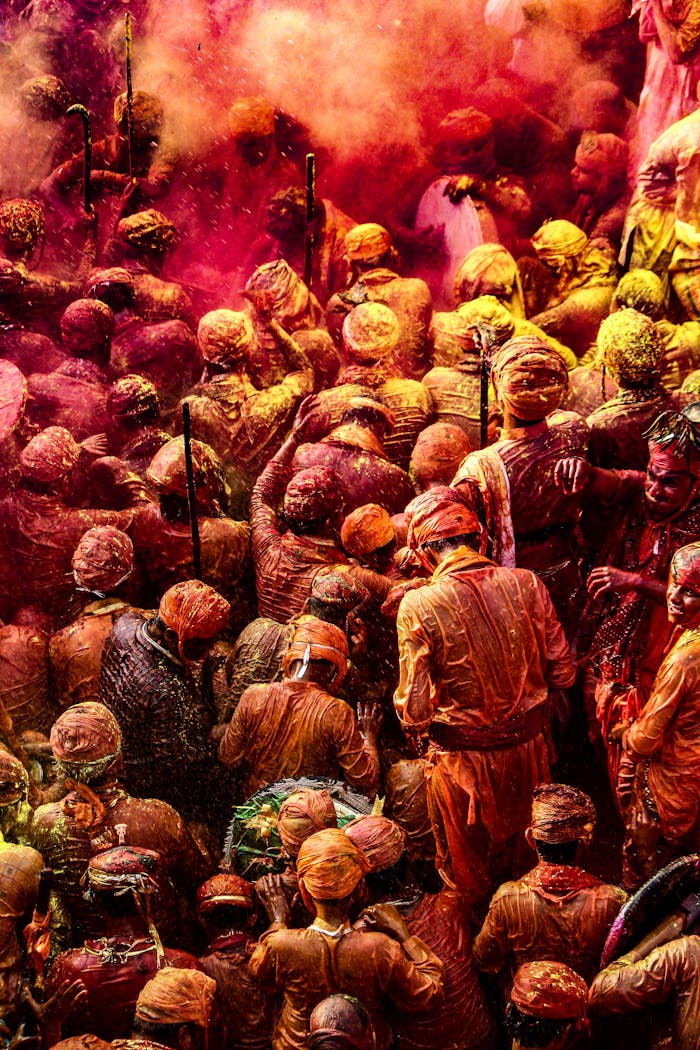 about-02 Colorful crowd celebrating Holi with vibrant powders in India.